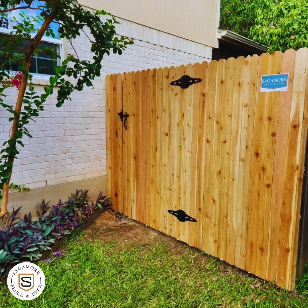 Light stained and sealed wooden fence with a gate and latch system.