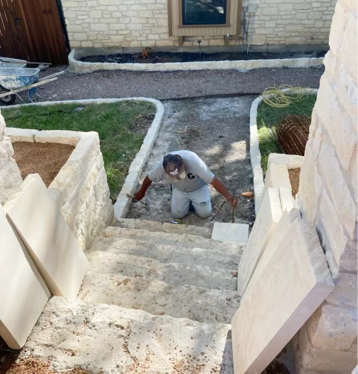 Fencing 7 Process image of stone steps being built, leading up to a home's front door.