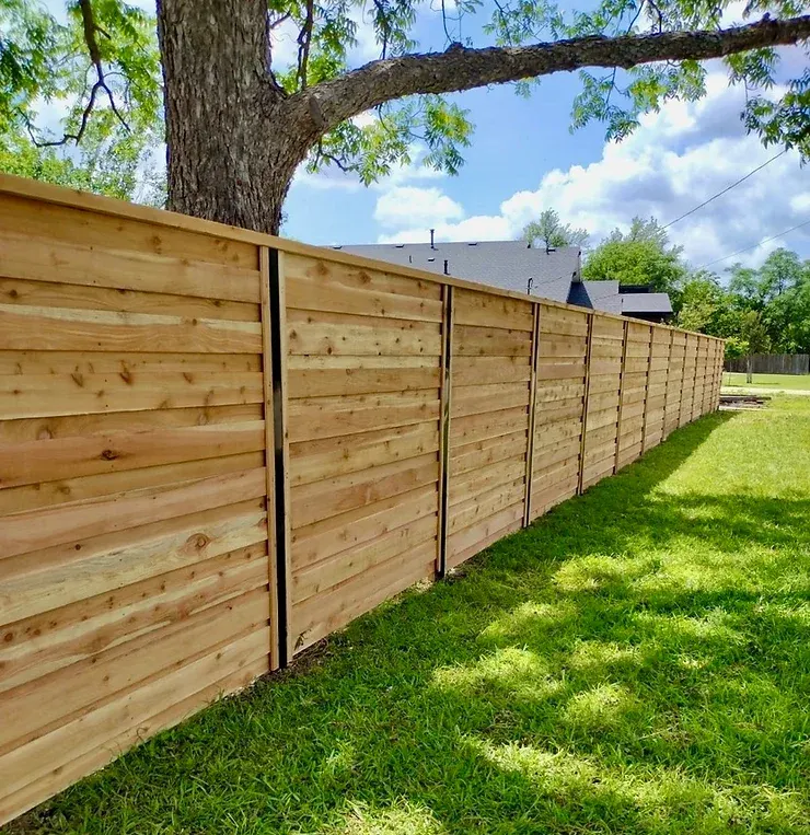 Custom wooden fence surrounding the backyard of an Austin home.