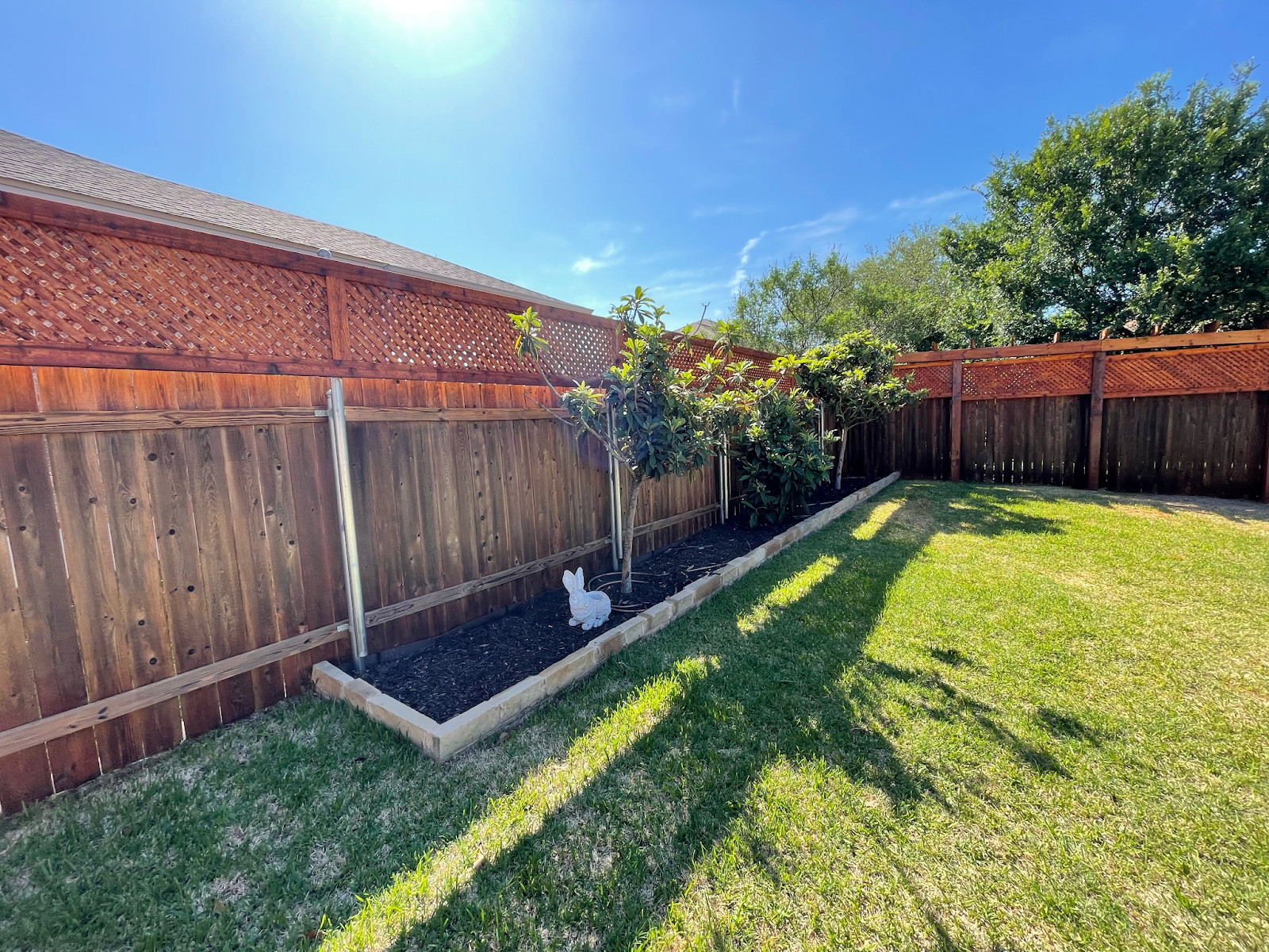 Wood privacy fence with lattice top addition. Located in Georgetown, Texas