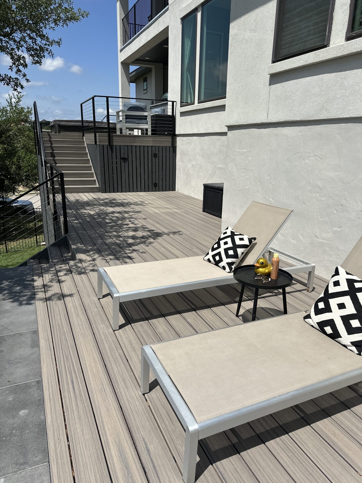 Composite deck with two chairs for lounging. Trex Deck built by Sagamore Fence & Deck