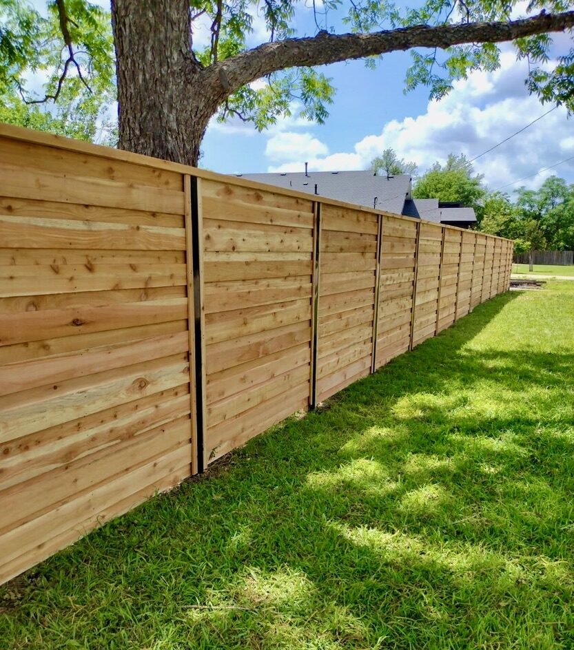Who Is Responsible for Fence Repair Between Neighbors in Texas? 1 Board on Board Wood Fence Installed by Sagamore Fence & Deck. Fence Builder in Georgetown TX