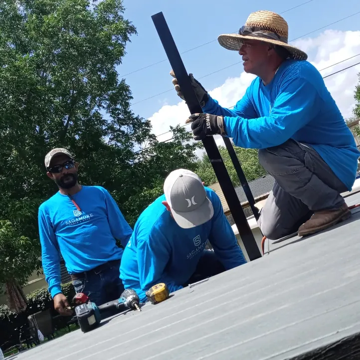 Sagamore crew installing a metal railing post on a composite deck