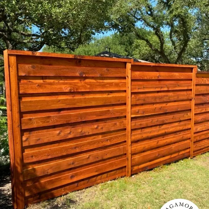 Close view of a stained horizontal cedar fence showing the wood grain