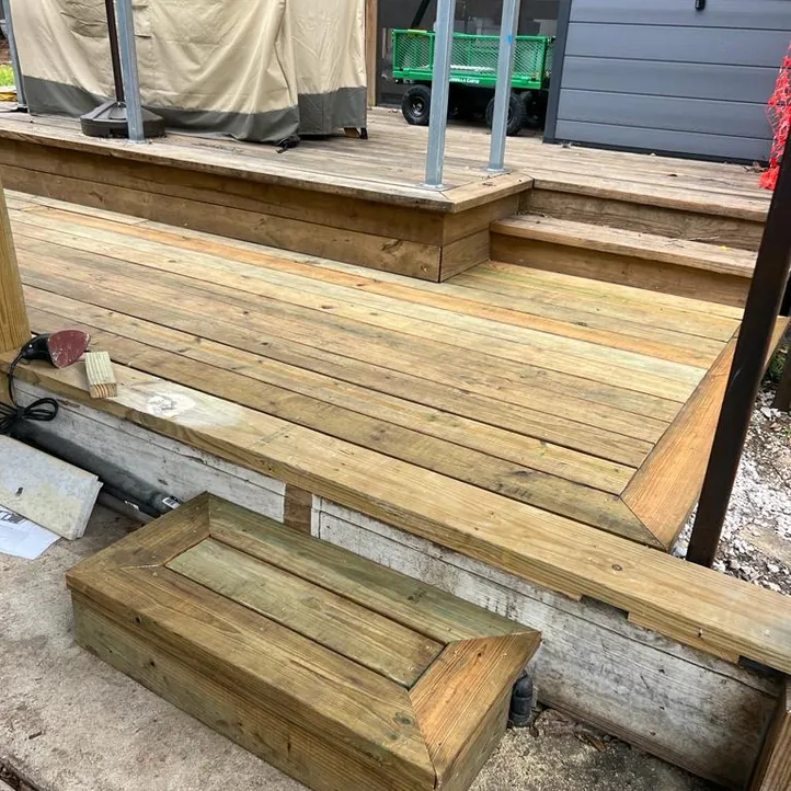 Wood deck and steps with a black steel railing